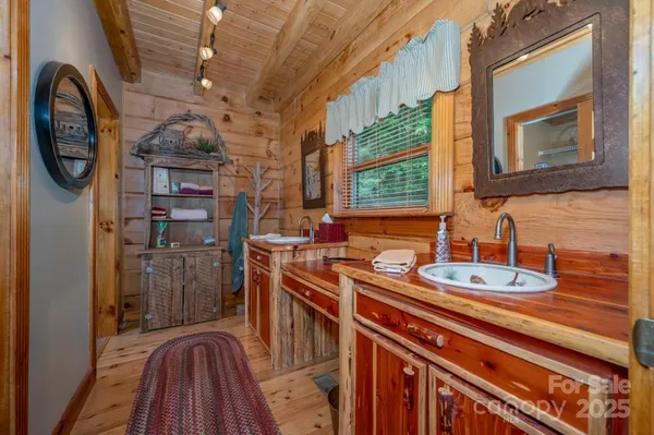 a bathroom with a sink a mirror and a window