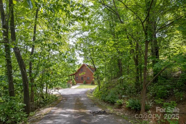 a view of a house with wooden fence and garden