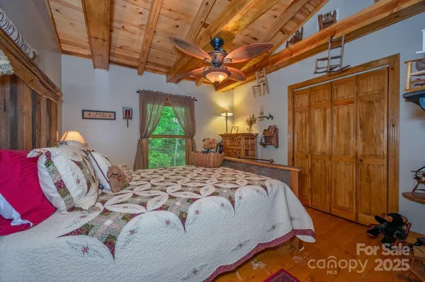 a bed sitting in a bedroom next to a window