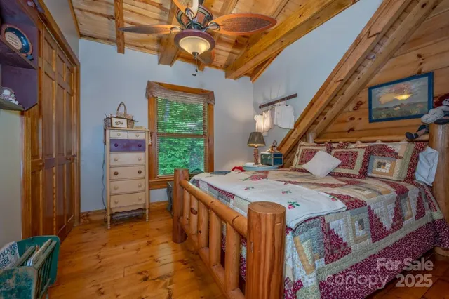 an aerial view of a house with a yard and a large tree