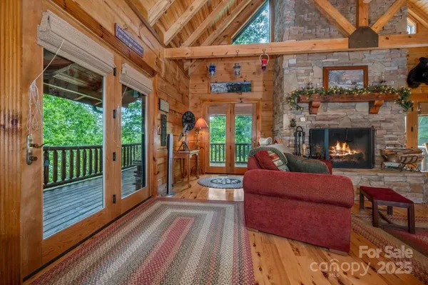a living room with furniture a fireplace and a floor to ceiling window