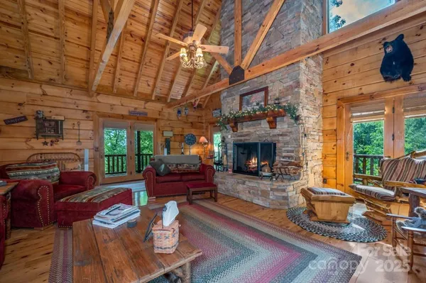a living room with furniture a fireplace and a table