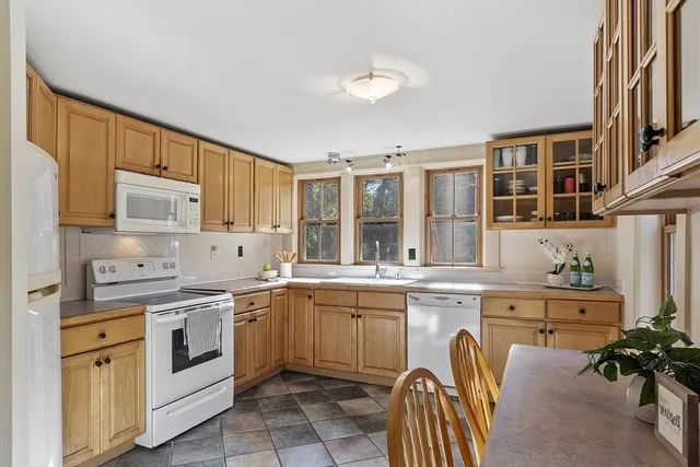 a kitchen with a stove sink and cabinets