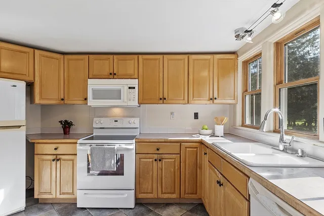 a kitchen with a sink stove and cabinets