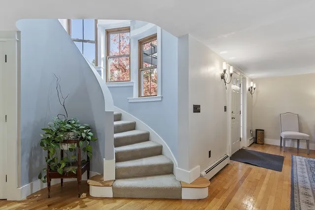 a view of entryway and hall with wooden floor
