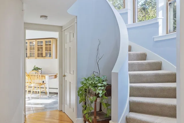 a view of an entryway with wooden floor and a livingroom
