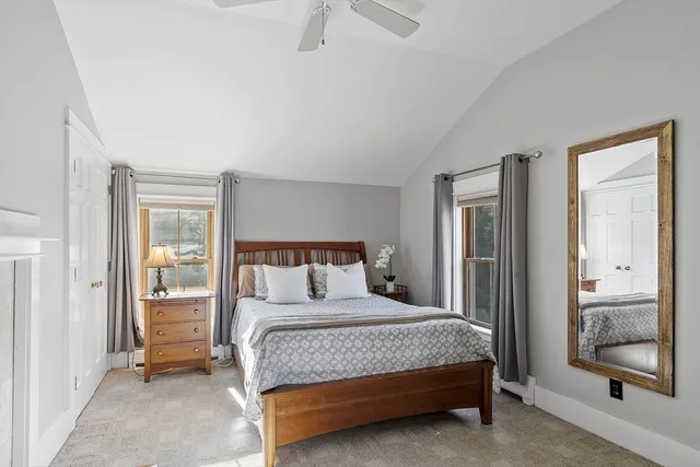 a bedroom with a bed and a mirror