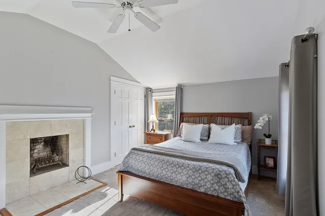 a bedroom with a bed and a fireplace