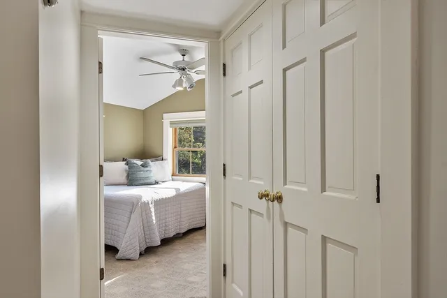 a bedroom with a bed table and a window