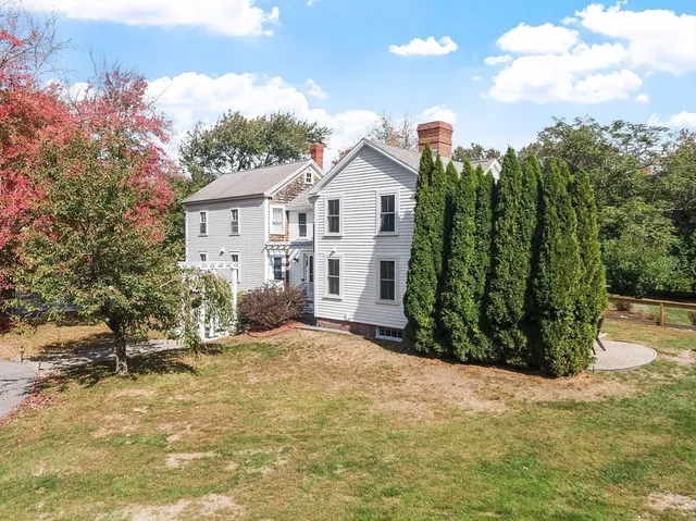 a view of a house with a yard and sitting area