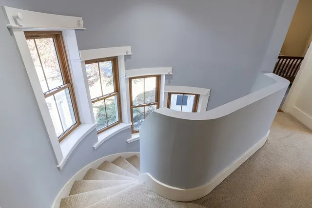 an aerial view of a house with a yard and lake view