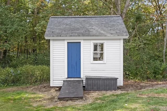 an aerial view of a house with a yard basket ball court and outdoor seating