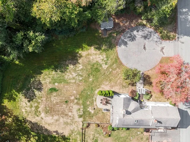 an aerial view of a houses with a yard