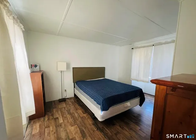 a room with a bed and a mirror