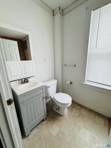 a bathroom with a sink a toilet and mirror