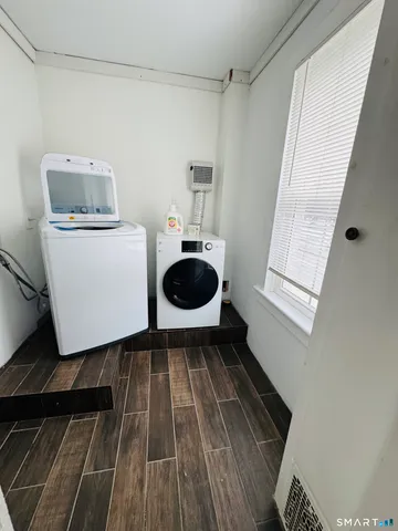 a bathroom with a toilet and a mirror