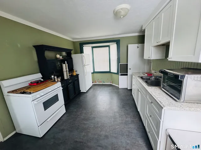 a kitchen that has a sink and a stove in it