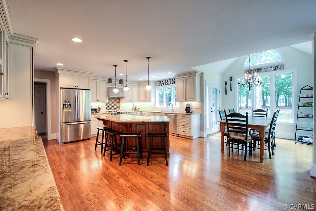 2600 Arrandell Road Midlothian, VA 23113 - Photo 17 of 45 a dining area with stainless steel appliances kitchen island granite countertop furniture and wooden floor