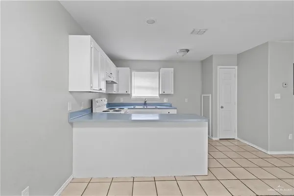 a kitchen with stainless steel appliances granite countertop a sink and a stove