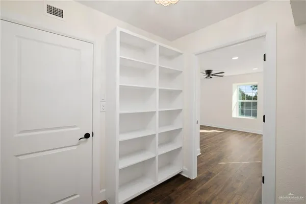 a view of a room with wooden floor and windows