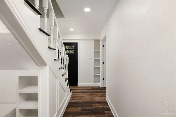 a view of a hallway with stairs