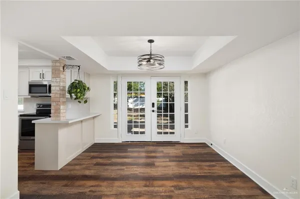 a kitchen with white cabinets sink and appliances