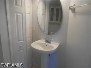 a bathroom with a sink and mirror