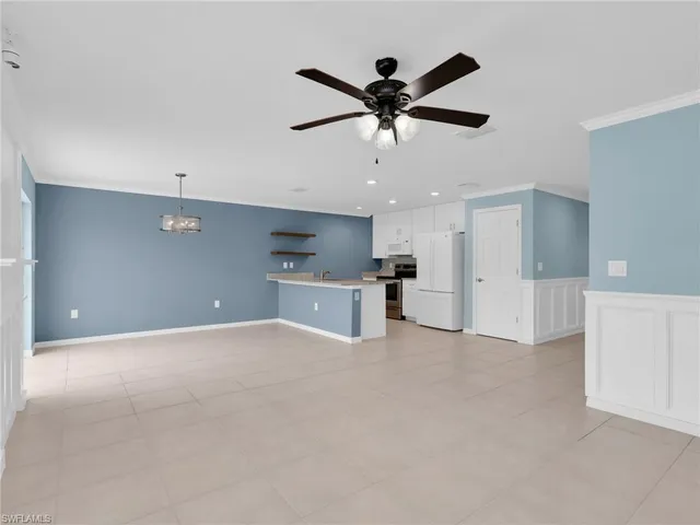 a view of a kitchen with a sink and a ceiling fan