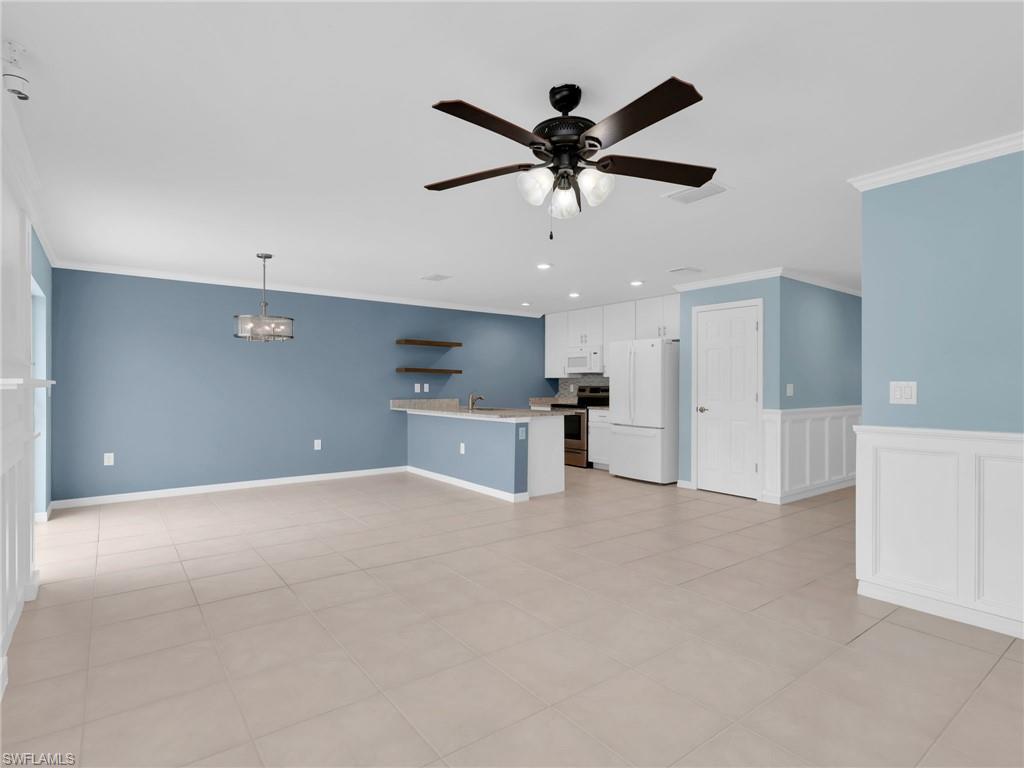 a view of a kitchen with a sink and a ceiling fan