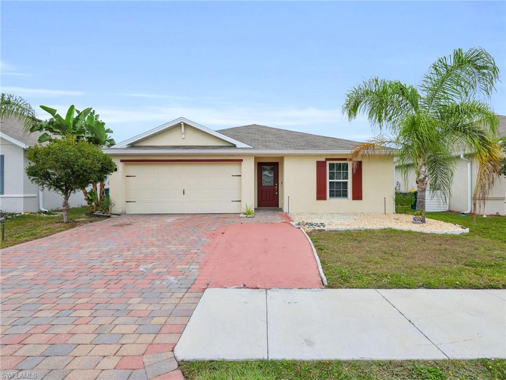 731 Hadley Place West Naples, FL 34104 - Photo 25 of 30 a front view of a house with a yard and garage
