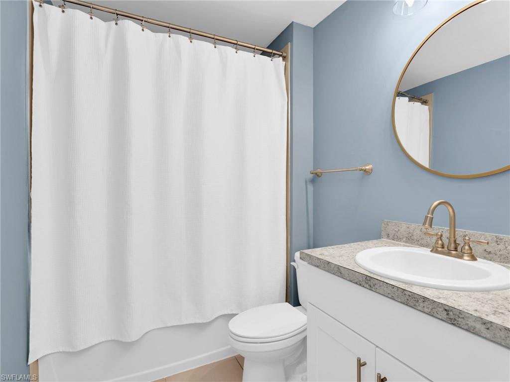 731 Hadley Place West Naples, FL 34104 - Photo 5 of 30 a bathroom with a granite countertop sink and a mirror