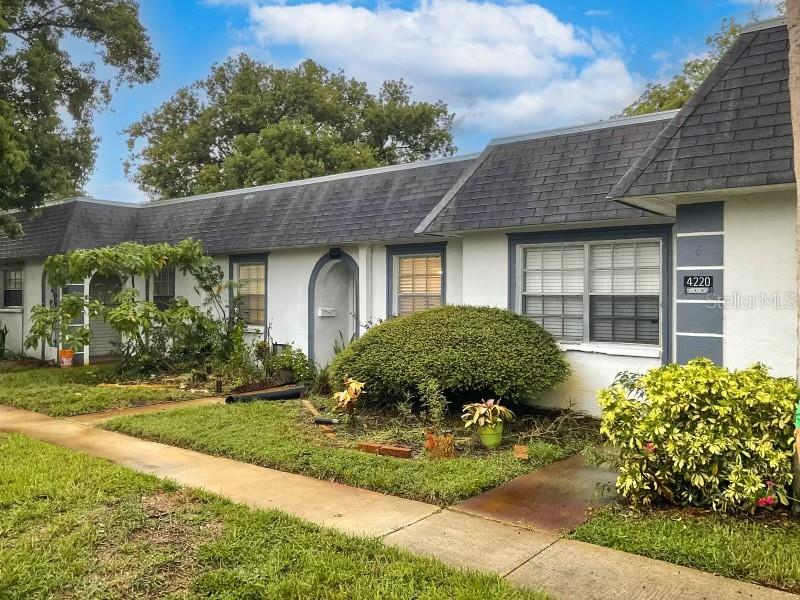4222 Trucious Place New Port Richey, FL 34652 - Photo 2 of 13 a front view of a house with garden