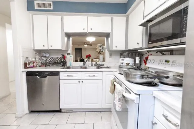 a kitchen with a sink and cabinets