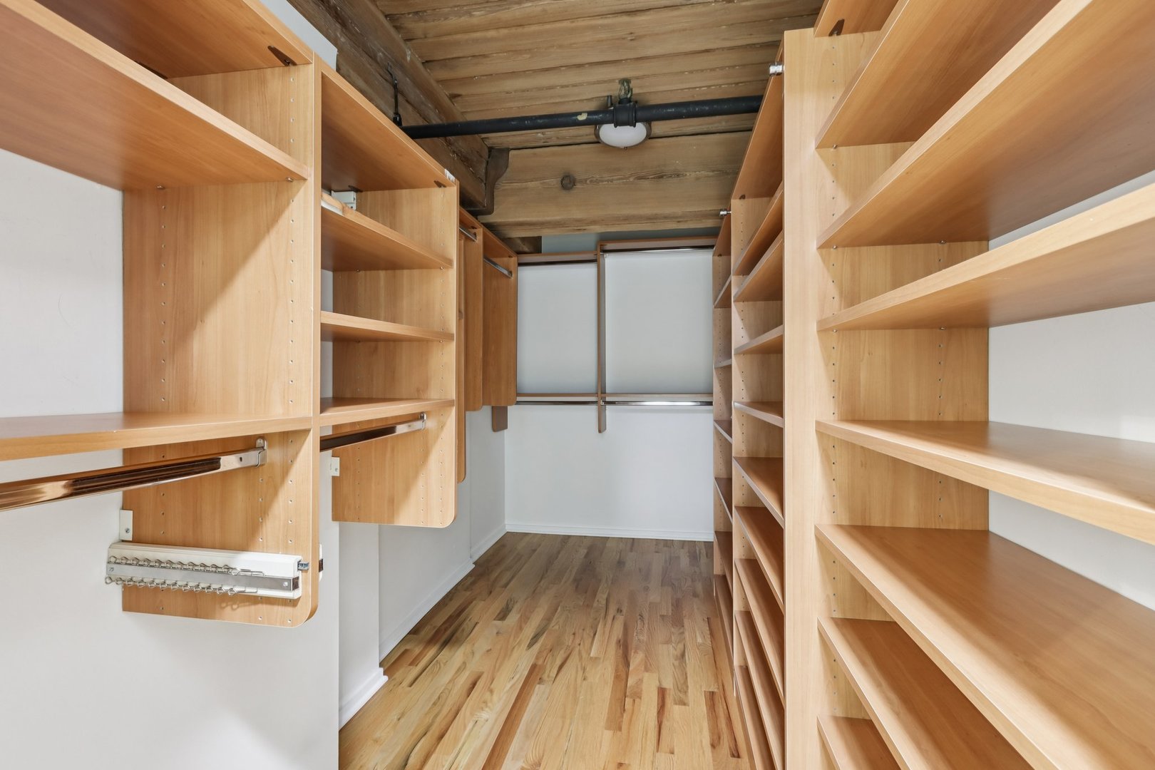 1000 West Washington Boulevard, Unit 137 Chicago, IL 60607 - Photo 17 of 33 a view of walk in closet with wooden floor