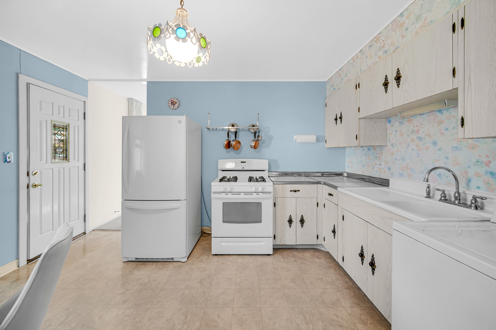 2800 School Drive Rolling Meadows, IL 60008 - Photo 8 of 23 a kitchen with stainless steel appliances a white refrigerator oven a sink dishwasher and white cabinets next to a window