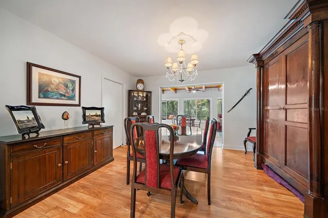 a bedroom with a bed a table and chair with the outer view