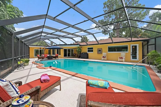a view of a patio with table and chairs under an umbrella