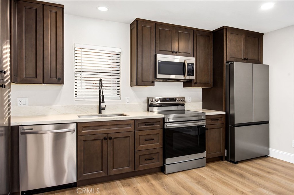 29566 Big Range Road, Unit 2 Canyon Lake, CA 92587 - Photo 18 of 27 a kitchen with stainless steel appliances granite countertop a refrigerator and a stove top oven