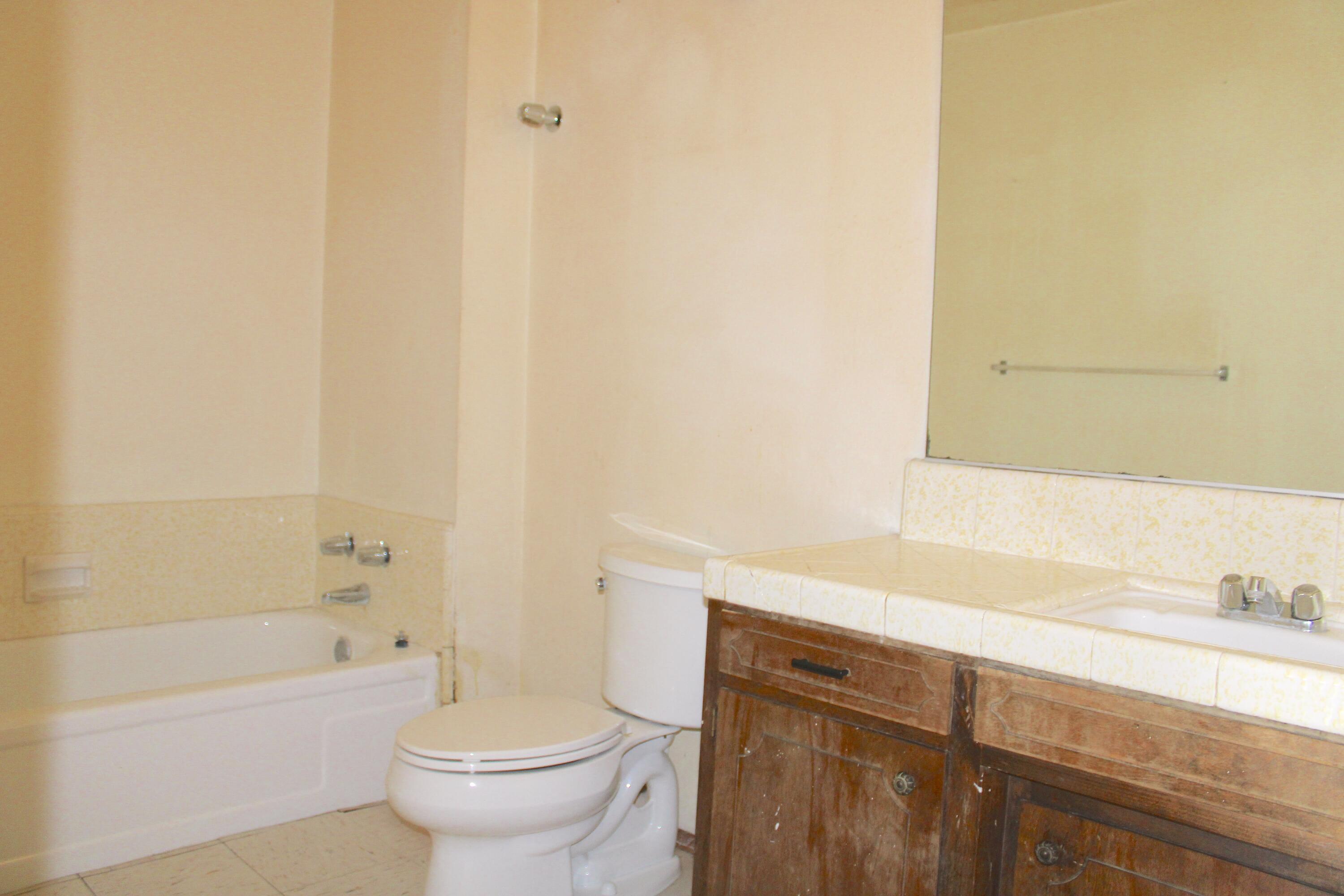 517 South R Street Tulare, CA 93274 - Photo 12 of 21 a bathroom with a sink a toilet and a bathtub