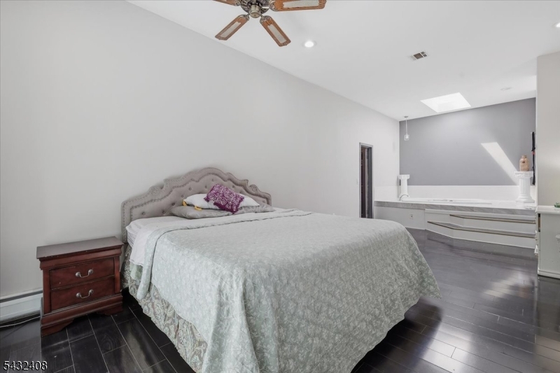 112 Knob Hill Road Hackettstown, NJ 07840 - Photo 21 of 32 a bedroom with a bed and wooden floor