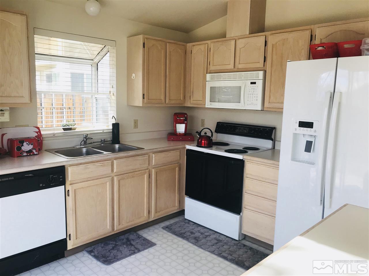 6396 Chesterfield Lane Reno, NV 89523 - Photo 11 of 21 a kitchen with a refrigerator sink and cabinets