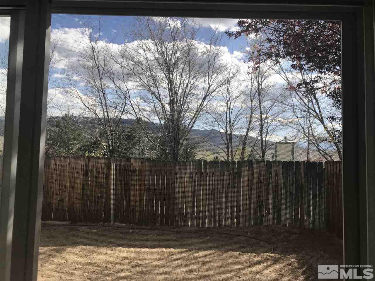 6396 Chesterfield Lane Reno, NV 89523 - Photo 12 of 21 a backyard of a house with large trees