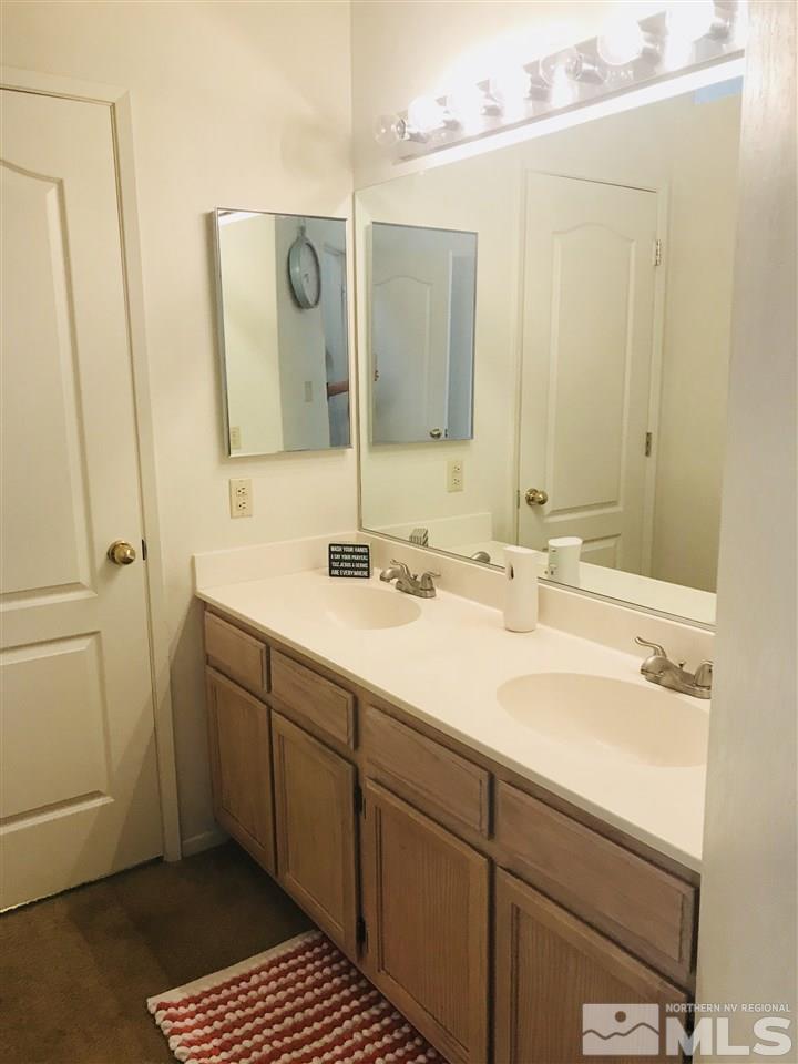 6396 Chesterfield Lane Reno, NV 89523 - Photo 16 of 21 a bathroom with a sink and a mirror