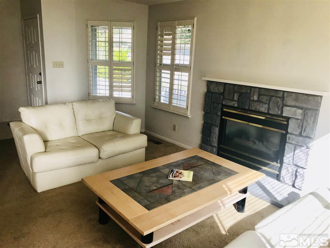 6396 Chesterfield Lane Reno, NV 89523 - Photo 5 of 21 a living room with furniture and a fireplace