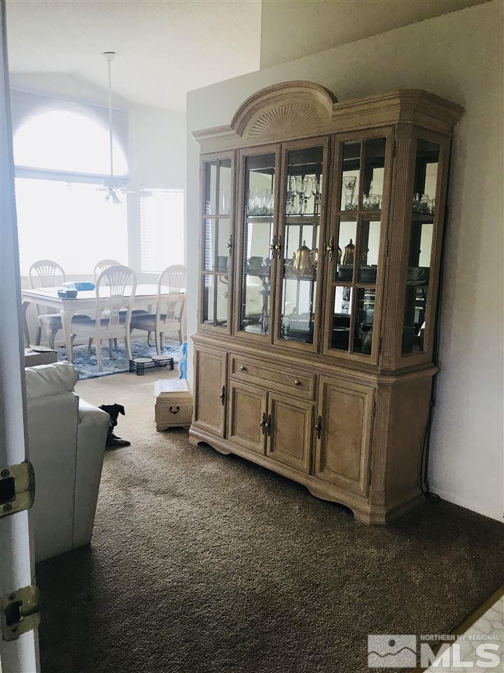 6396 Chesterfield Lane Reno, NV 89523 - Photo 6 of 21 a living room with furniture and a floor to ceiling window