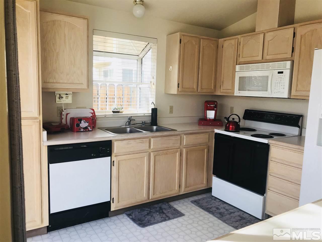 6396 Chesterfield Lane Reno, NV 89523 - Photo 9 of 21 a kitchen with a sink stove and cabinets