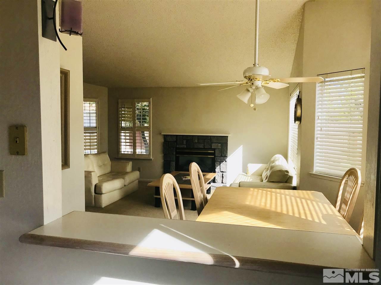 6396 Chesterfield Lane Reno, NV 89523 - Photo 10 of 21 a bedroom with furniture and a fireplace