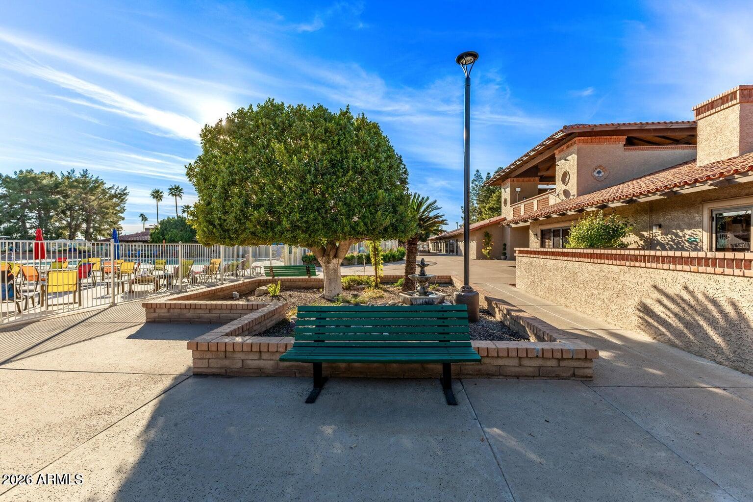 111 South Greenfield Road, Unit 547 Mesa, AZ 85206 - Photo 32 of 38 a backyard of a house with table and chairs