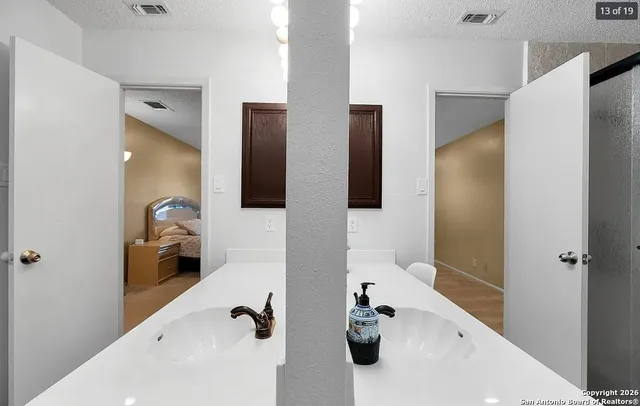 a bathroom with a sink and mirror