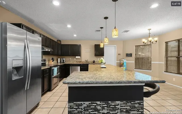 a kitchen with a table and chairs